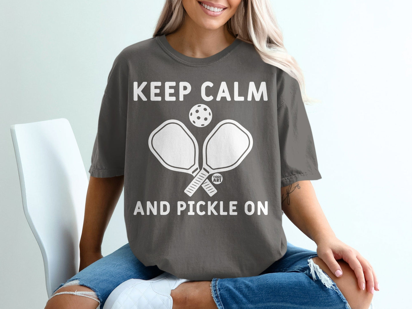 Gray t-shirt with "Keep Calm and Pickle On" text and pickleball paddles.