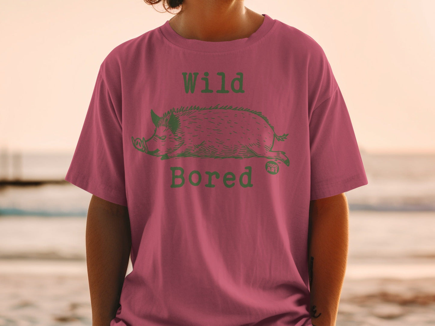 T-shirt with a green wild boar graphic and "Wild Bored" text.