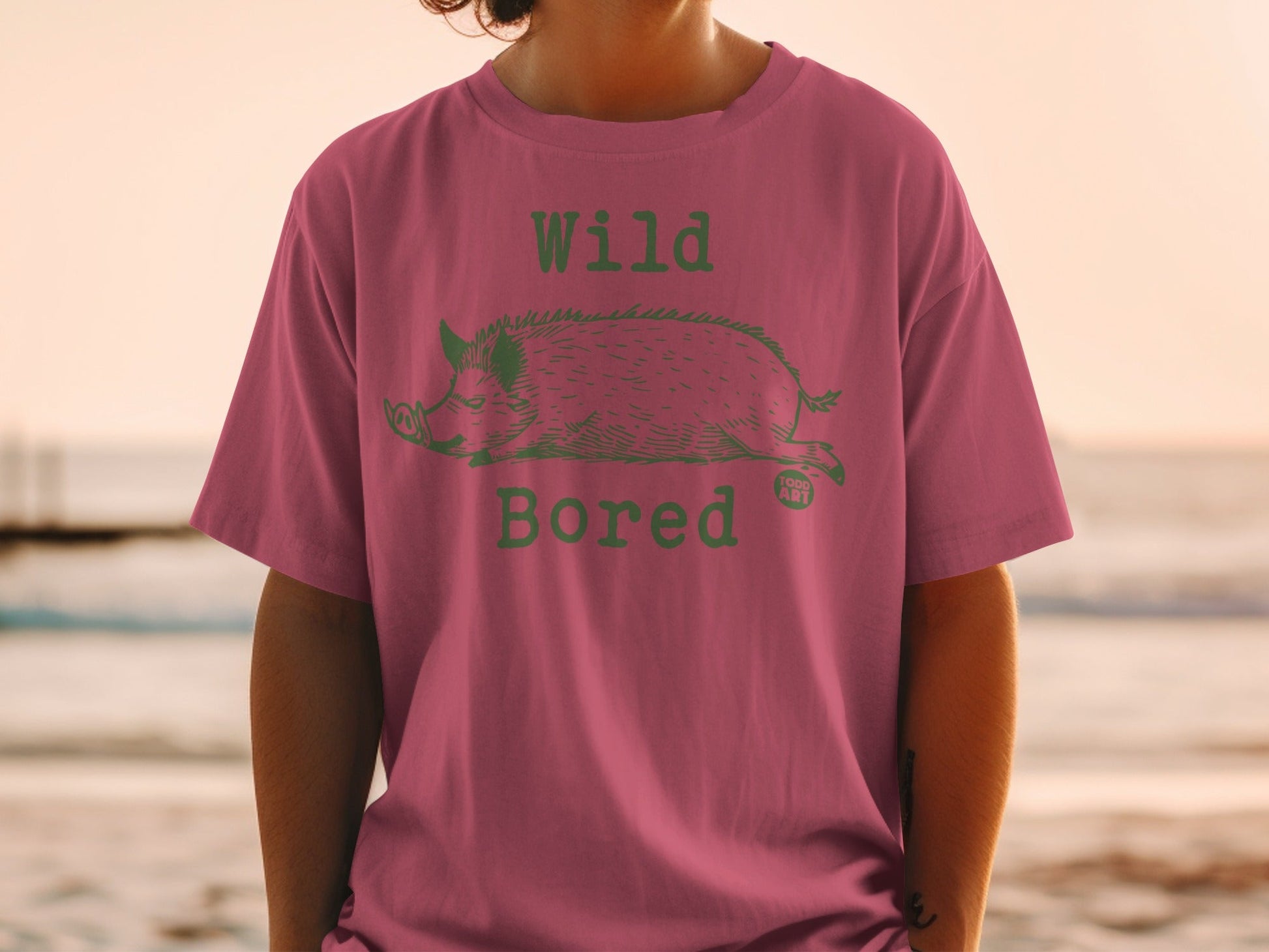 T-shirt with a green wild boar graphic and "Wild Bored" text.