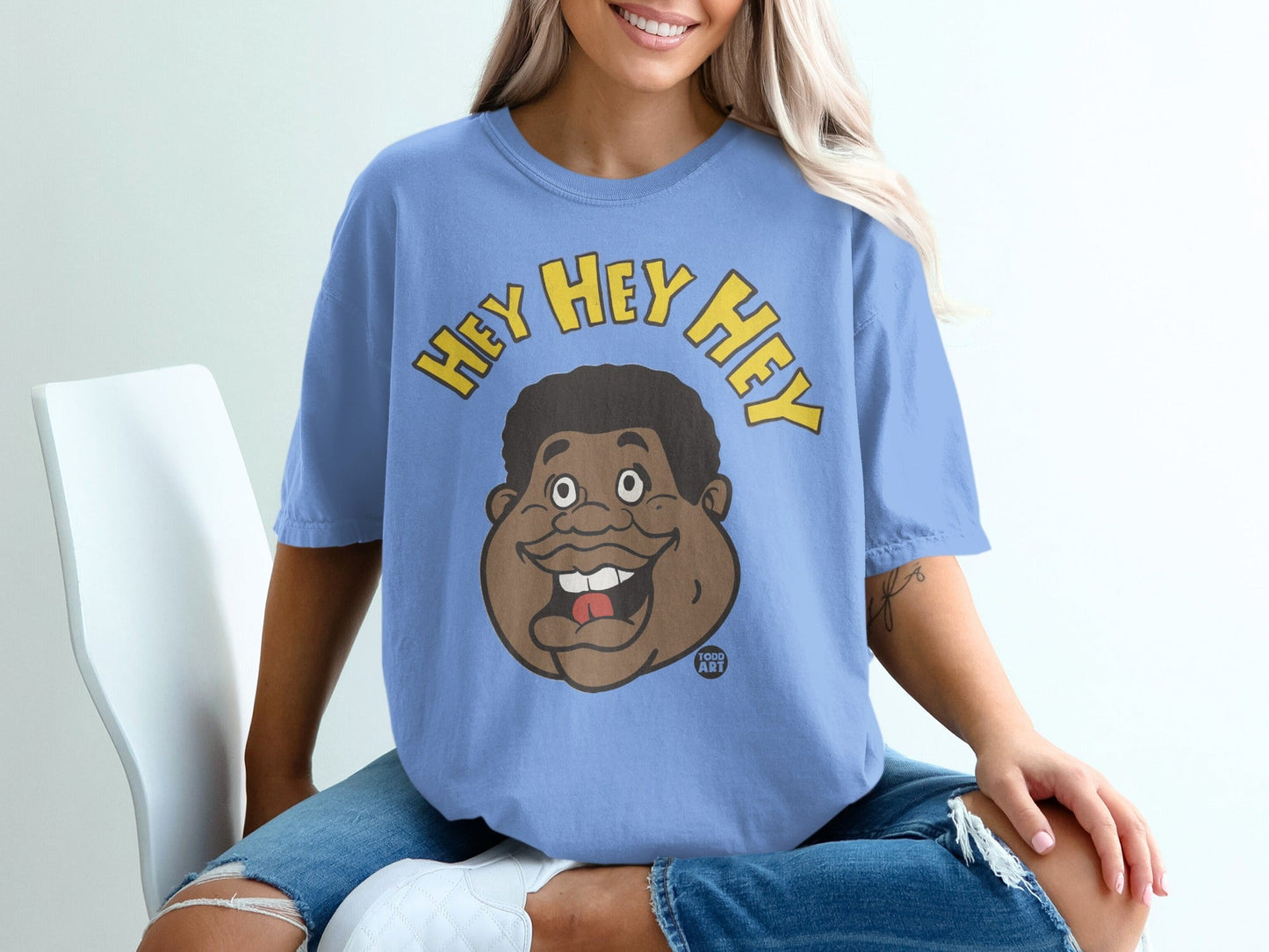 Light blue t-shirt with "HEY HEY HEY" and a cartoon face.
