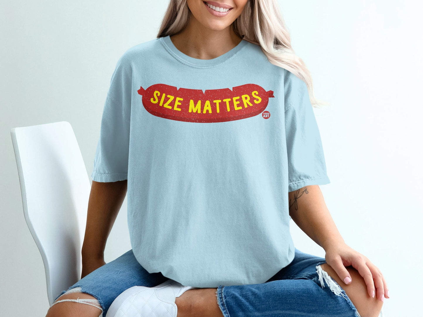 Light blue t-shirt with red "Size Matters" text in a sausage shape.
