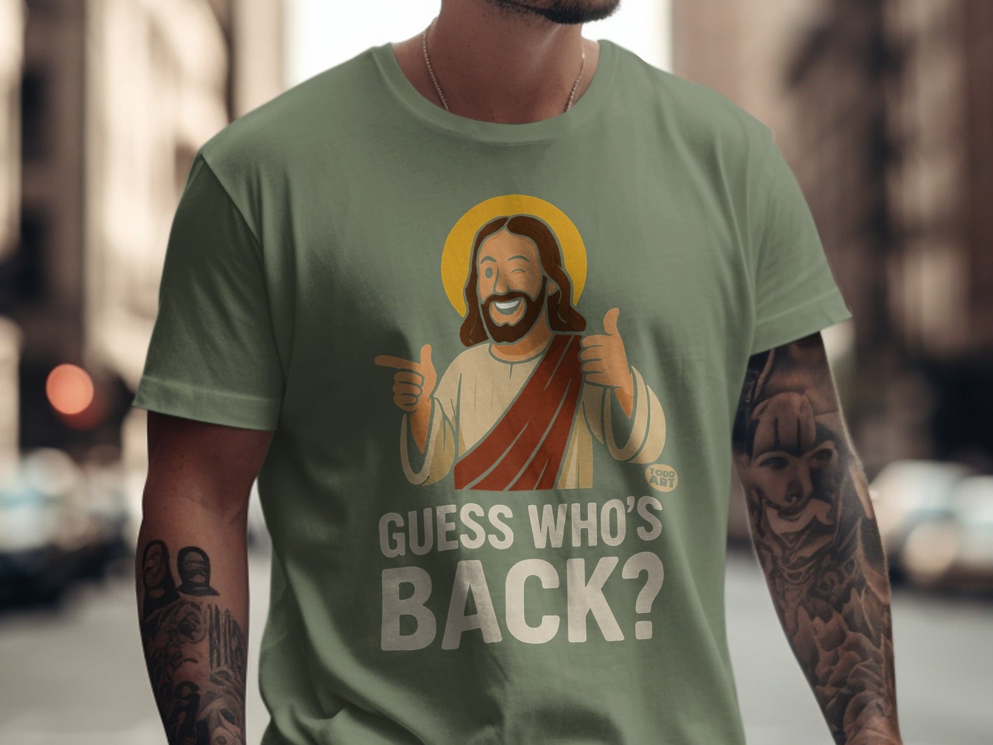 T-shirt with Jesus graphic, halo, thumbs up, and text "GUESS WHO'S BACK?".
