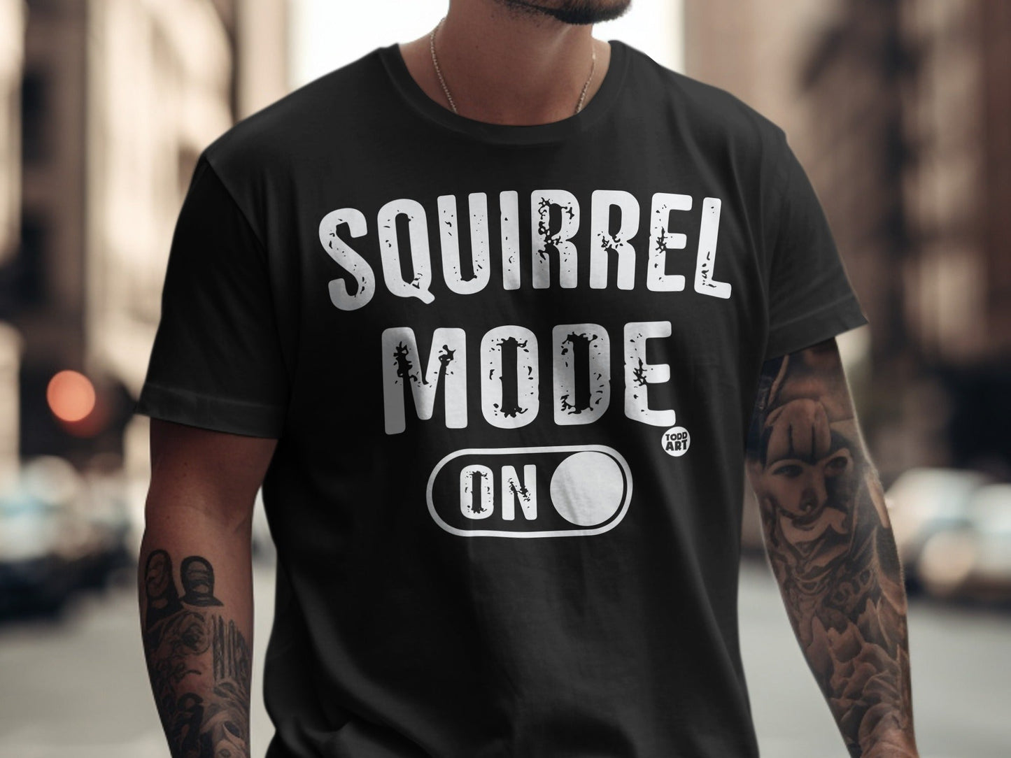 Black t-shirt with "SQUIRREL MODE ON" text and a toggle switch graphic.