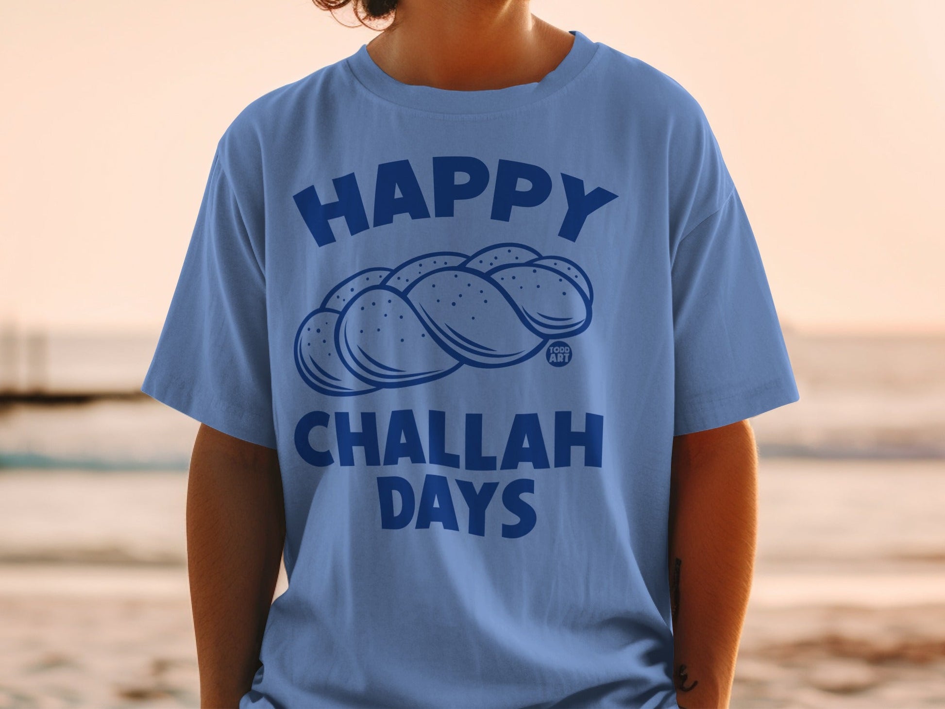 Blue t-shirt with "Happy Challah Days" text and braided bread graphic.