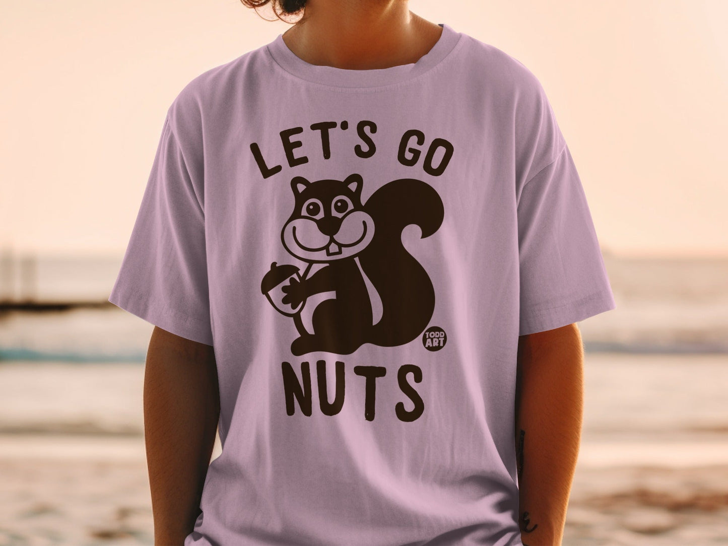 T-shirt with cartoon squirrel holding acorn, text "LET'S GO NUTS".