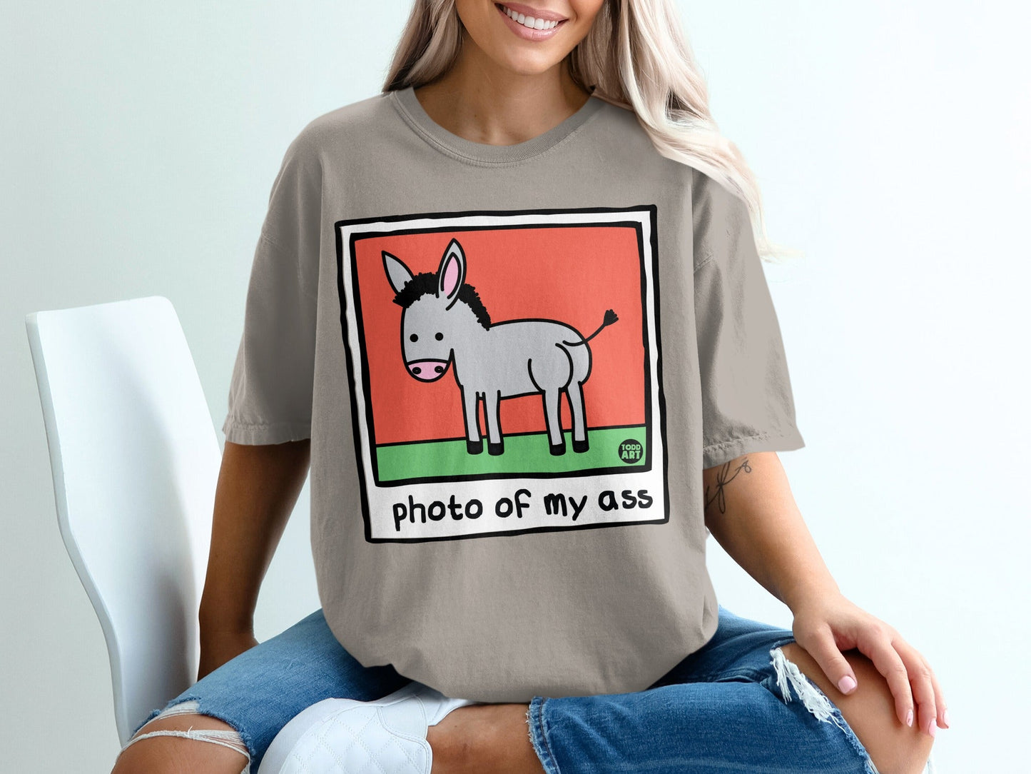Cartoon donkey with "photo of my ass" text on a t-shirt.
