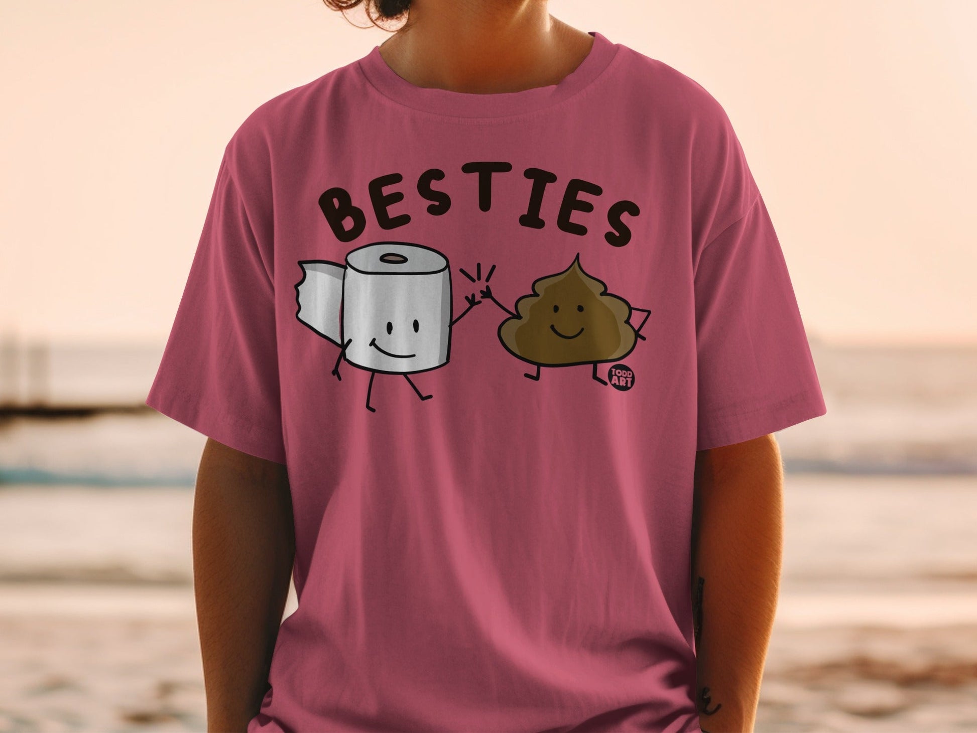 T-shirt with cartoon toilet paper and poop characters high-fiving, saying "BESTIES".