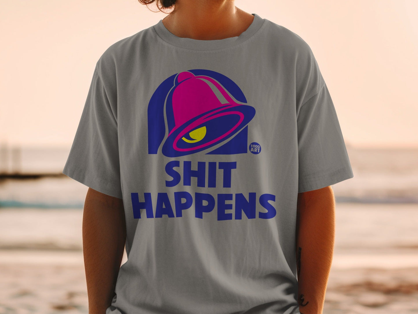 Grey t-shirt with Taco Bell bell logo and "SHIT HAPPENS" text.