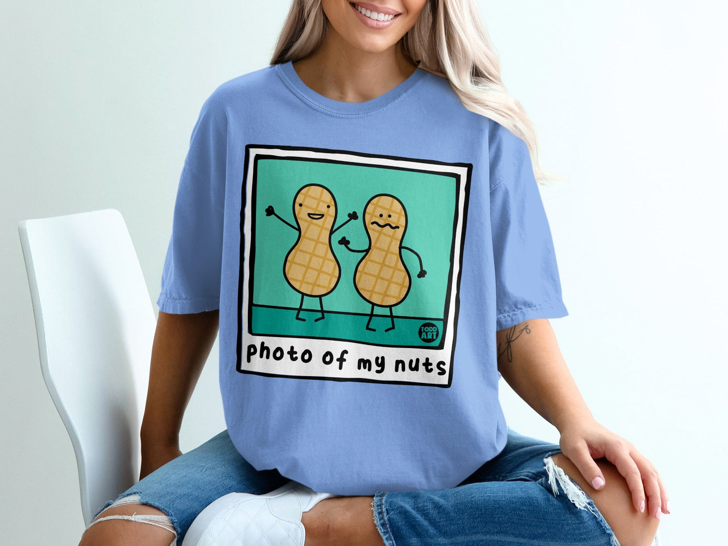 Two cartoon peanuts with smiling faces and stick arms, "photo of my nuts" text.