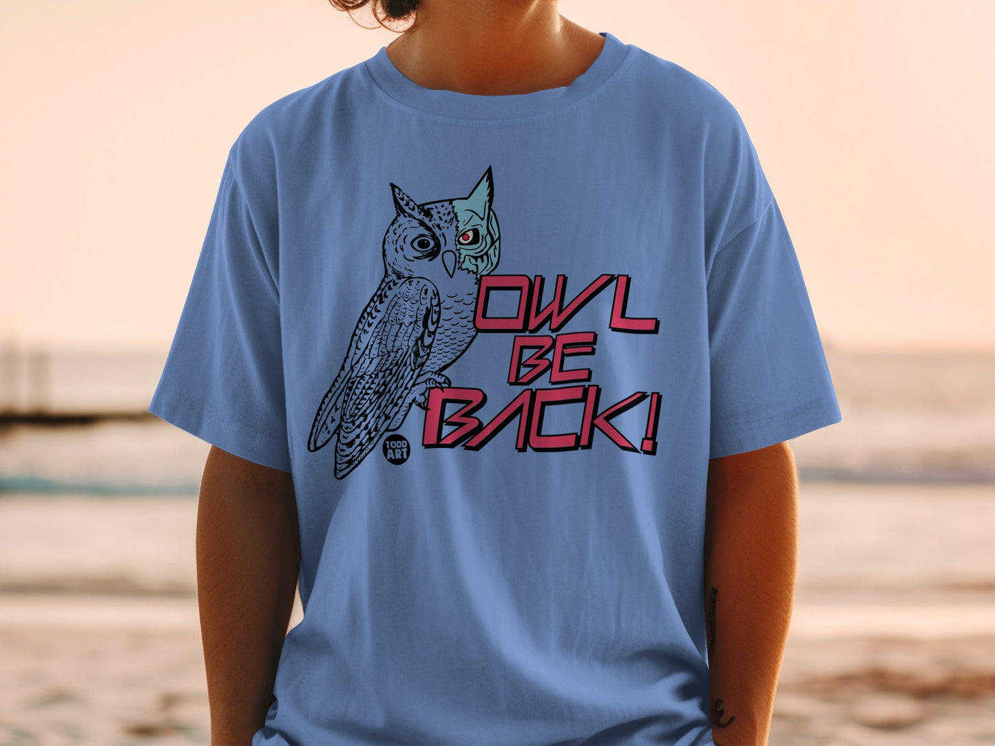 Blue t-shirt with a black and pink owl graphic and "OWL BE BACK!" text.