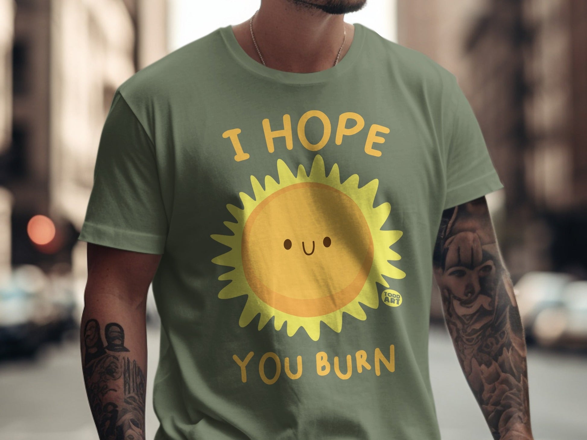 Green t-shirt with a smiling sun graphic and the text "I HOPE YOU BURN".