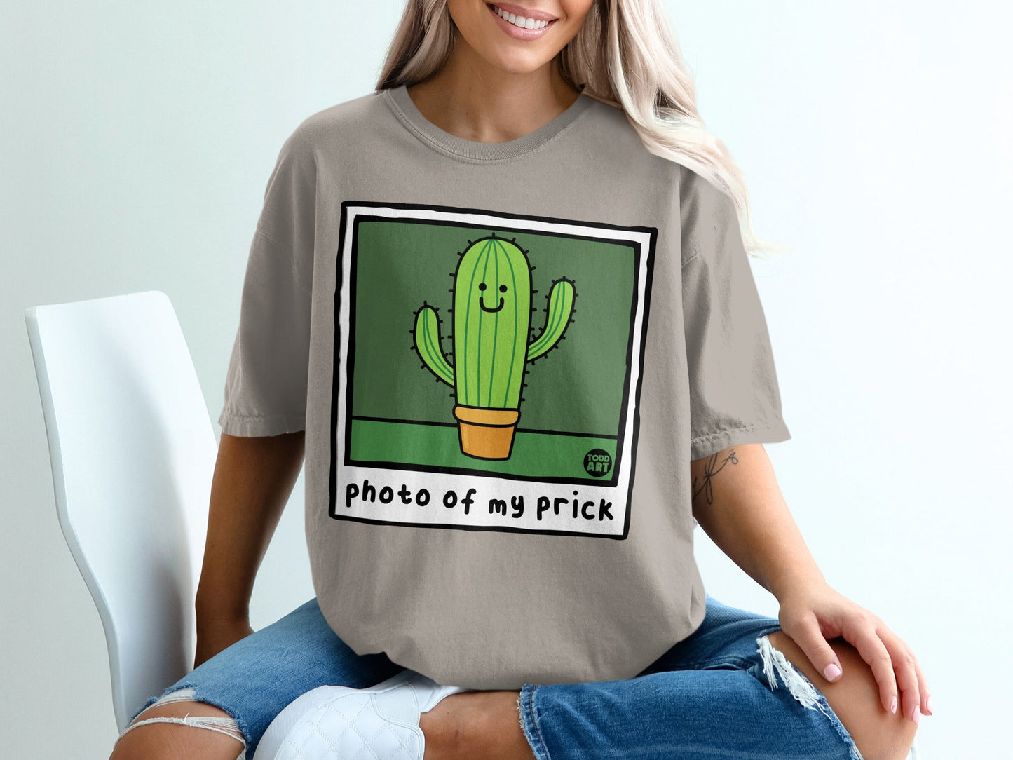 T-shirt graphic with smiling cartoon cactus and text "photo of my prick".