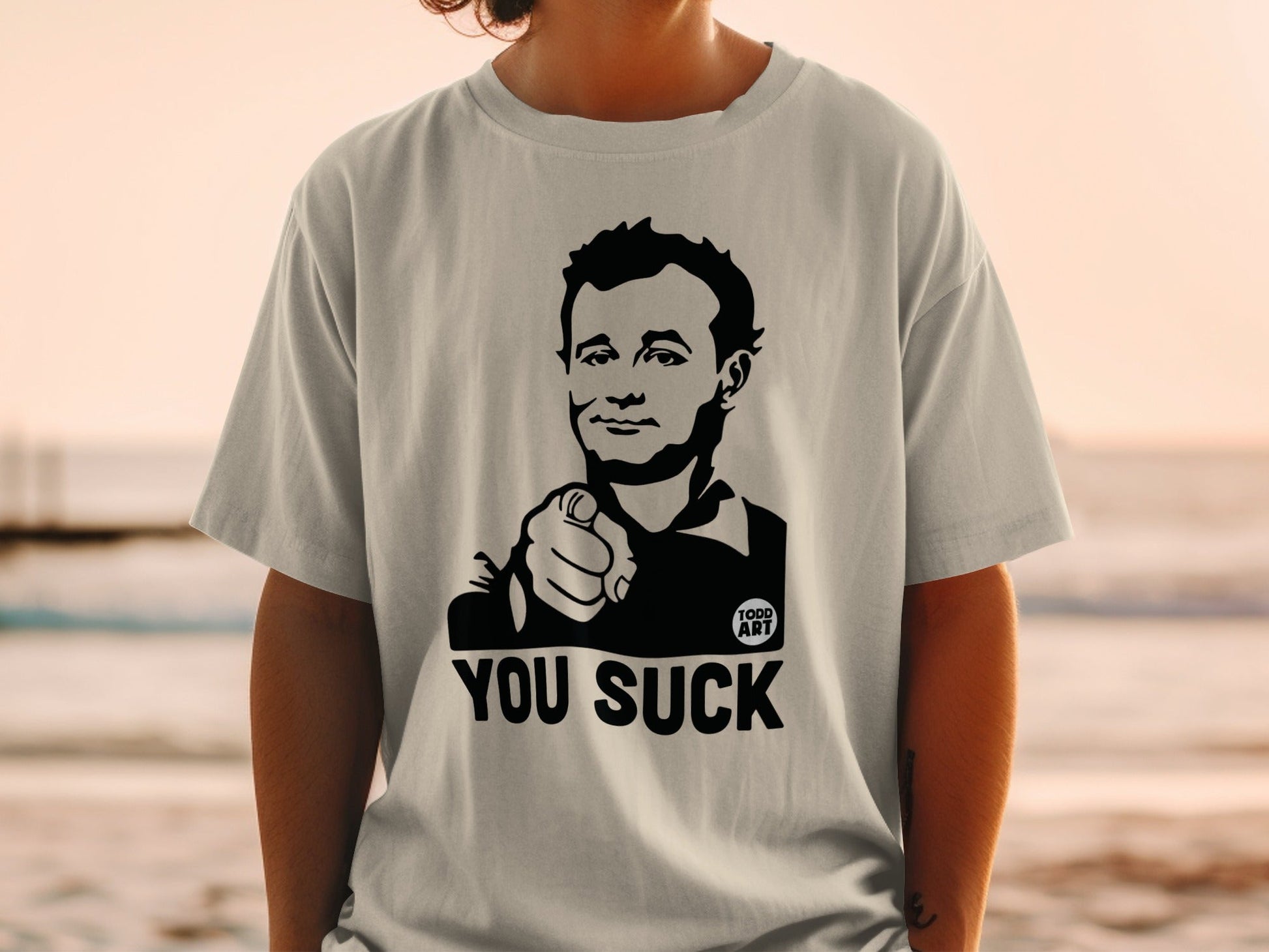 T-shirt with a black and white illustration of Bill Murray pointing and text that reads "YOU SUCK".