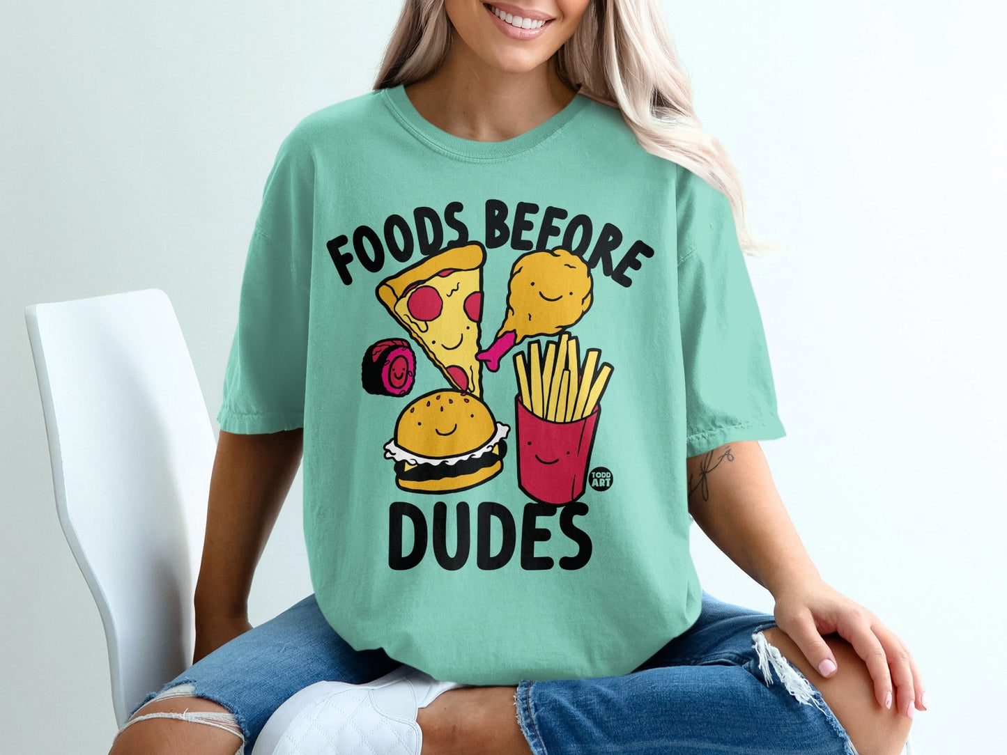 Teal t-shirt with cartoon pizza, burger, fries, and chicken leg.