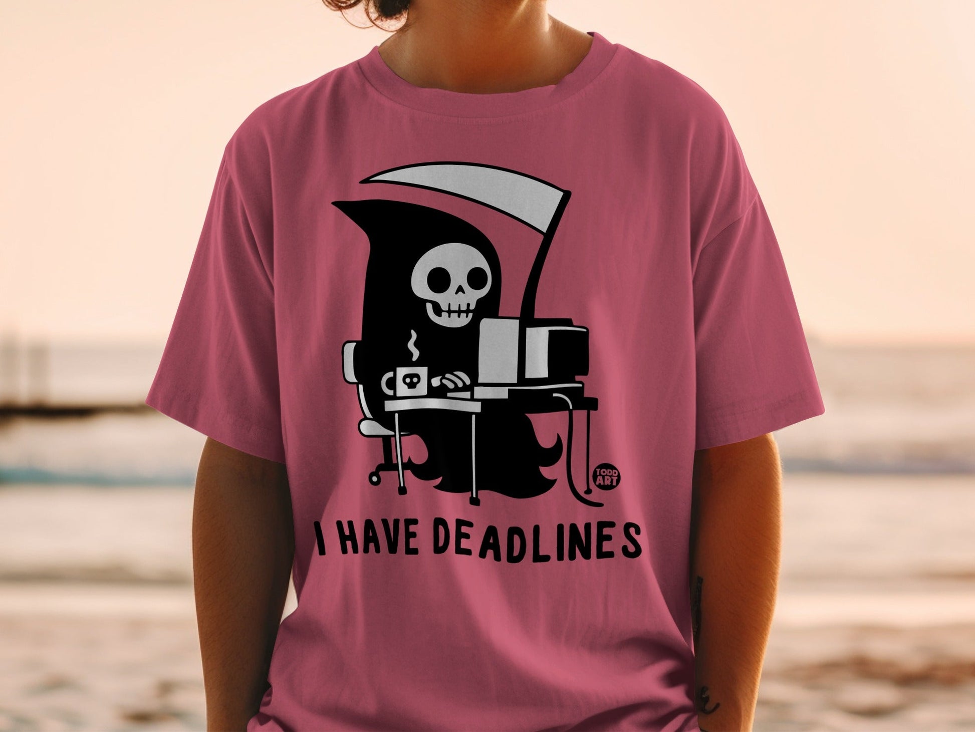 Pink t-shirt with Grim Reaper at computer, "I HAVE DEADLINES" text.