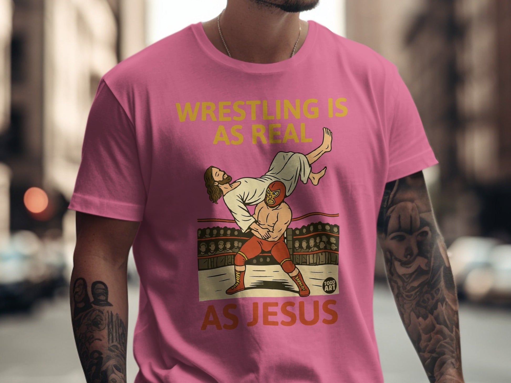 Wrestling is real as Jesus graphic on pink t-shirt.