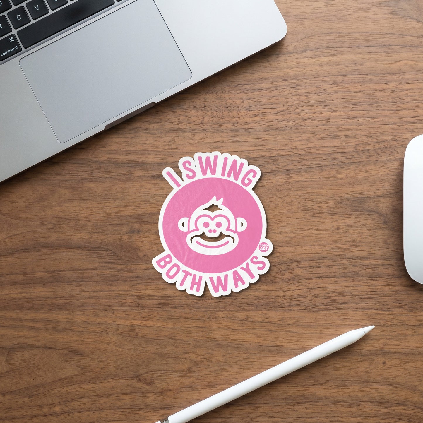 Pink sticker with monkey graphic and text "I swing both ways".