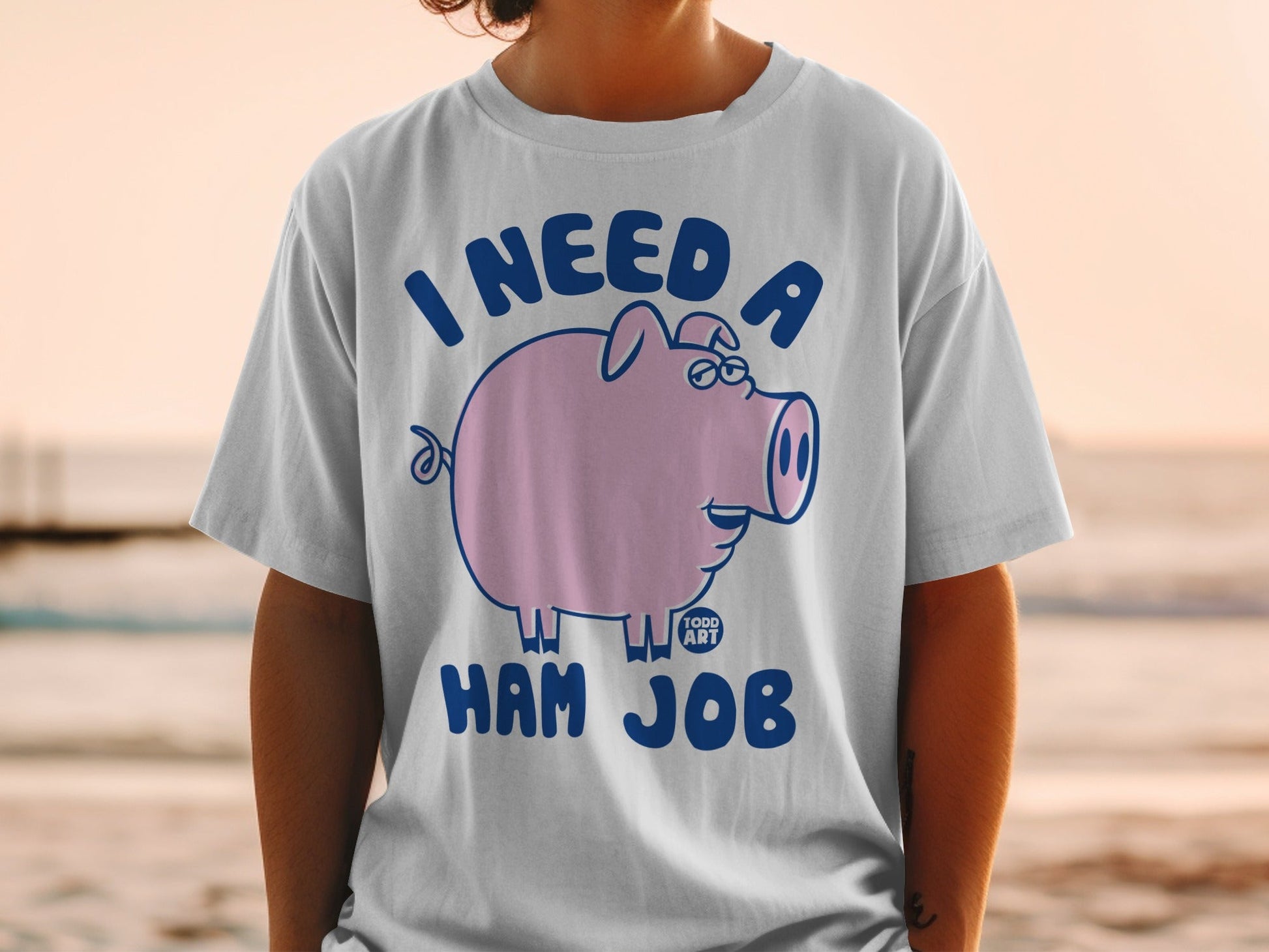 T-shirt with a cartoon pig wearing glasses and the text "I need a ham job".