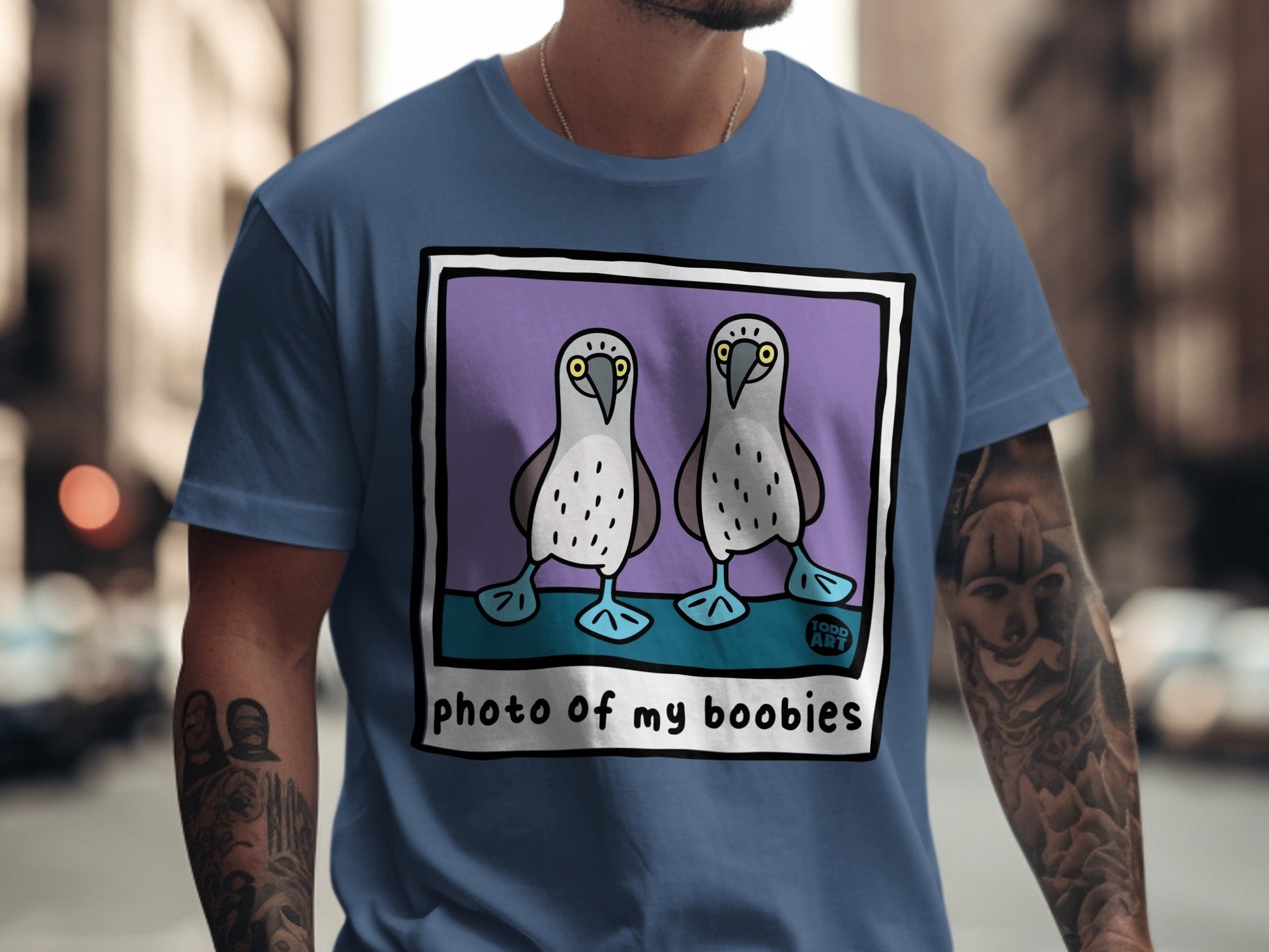 Two cartoon boobies with "TODD ART" text on a blue t-shirt.