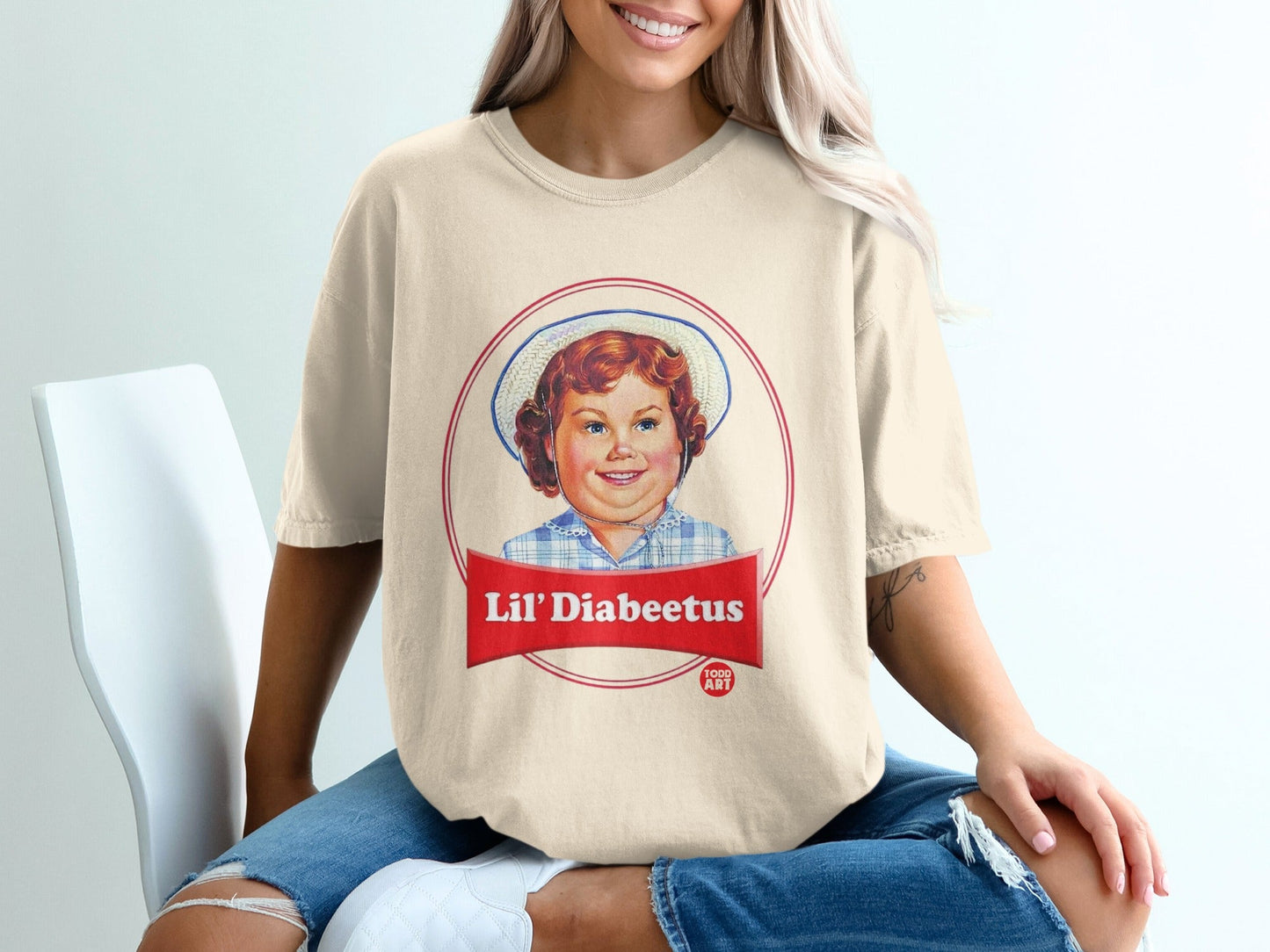 Cream t-shirt with Lil' 'Diabeetus' graphic featuring a child in a hat.