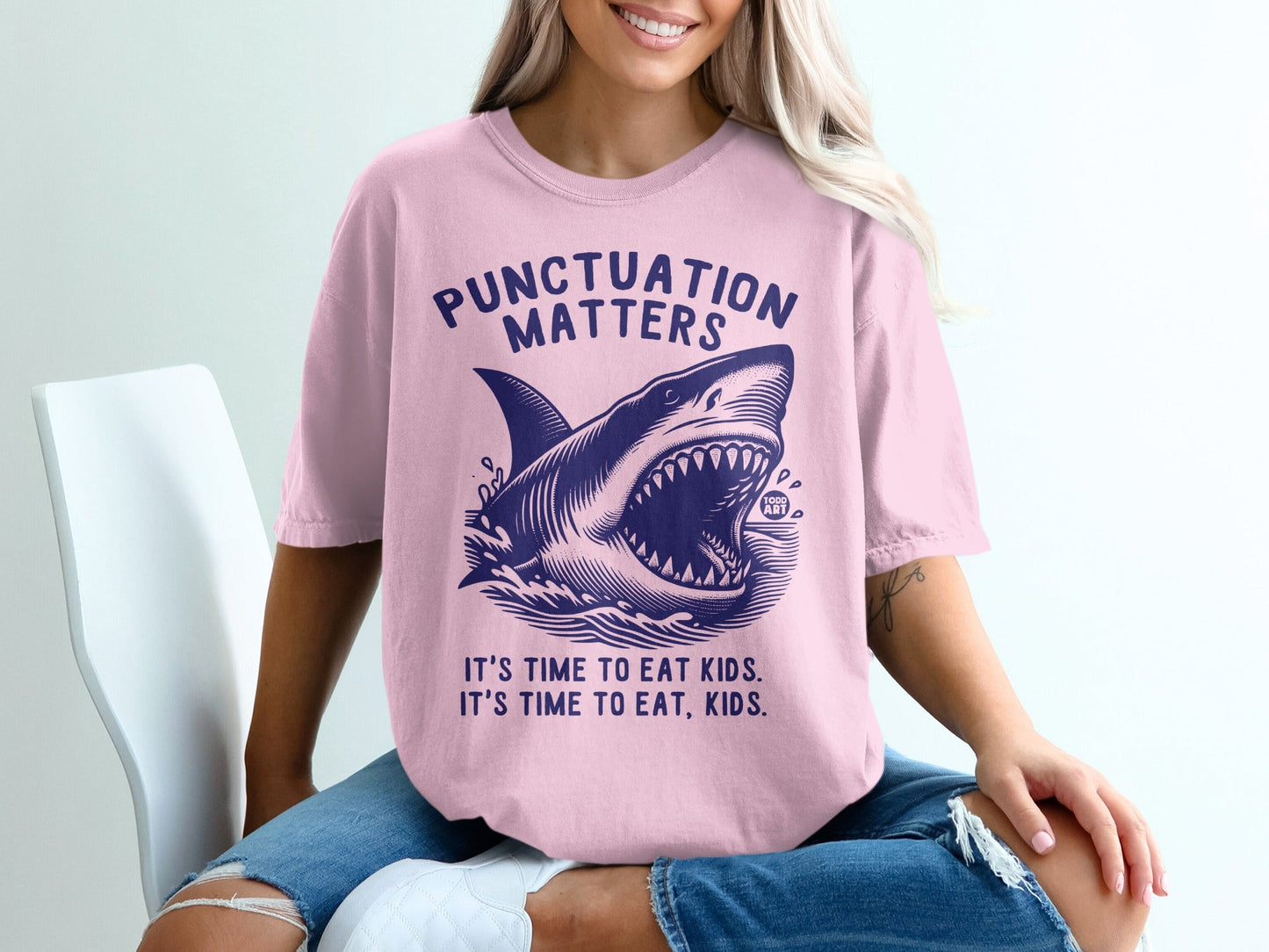 Pink t-shirt with shark graphic and "Punctuation Matters" text.