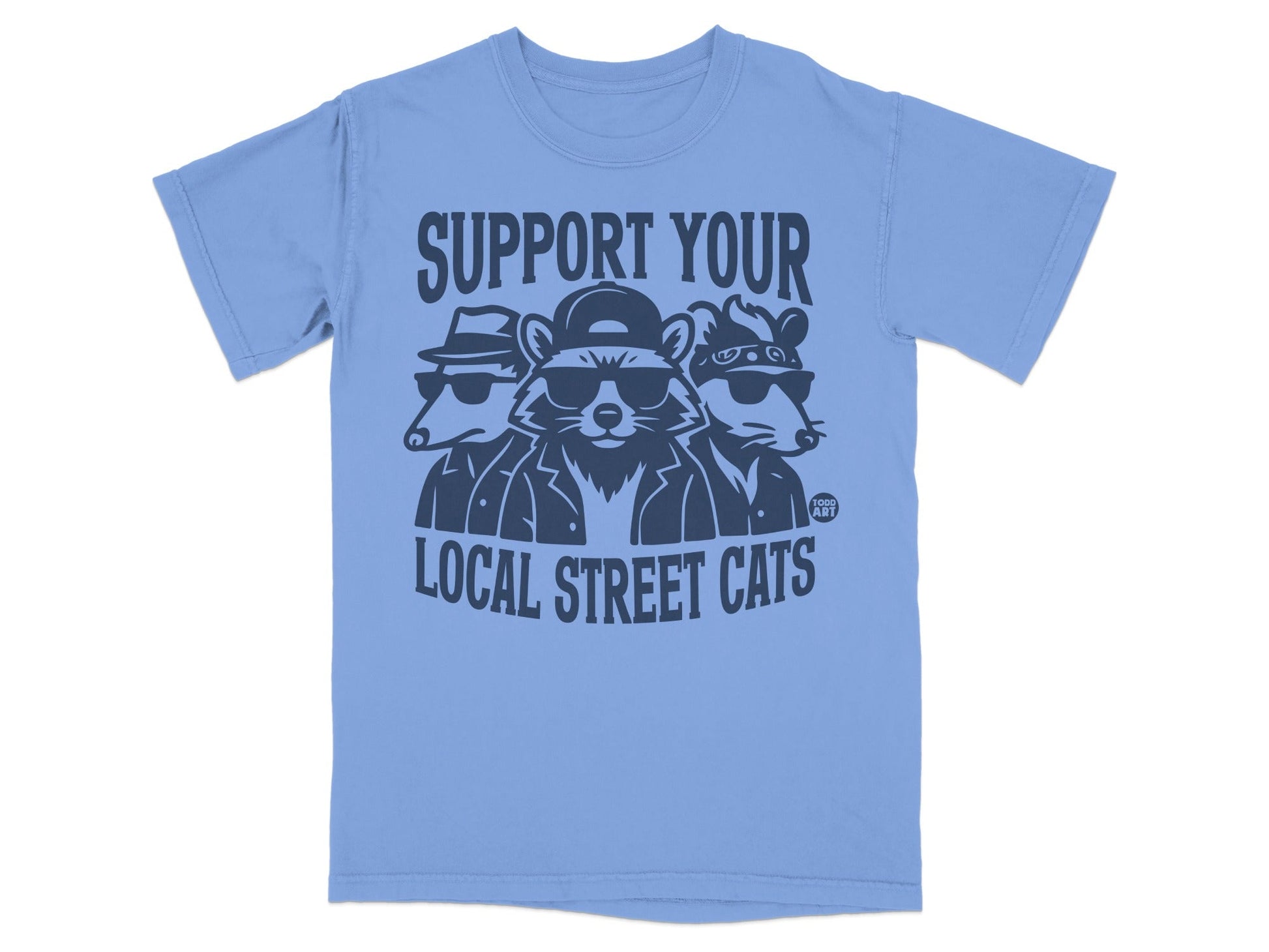 Three cartoon cats wearing sunglasses and hats on a light blue t-shirt.