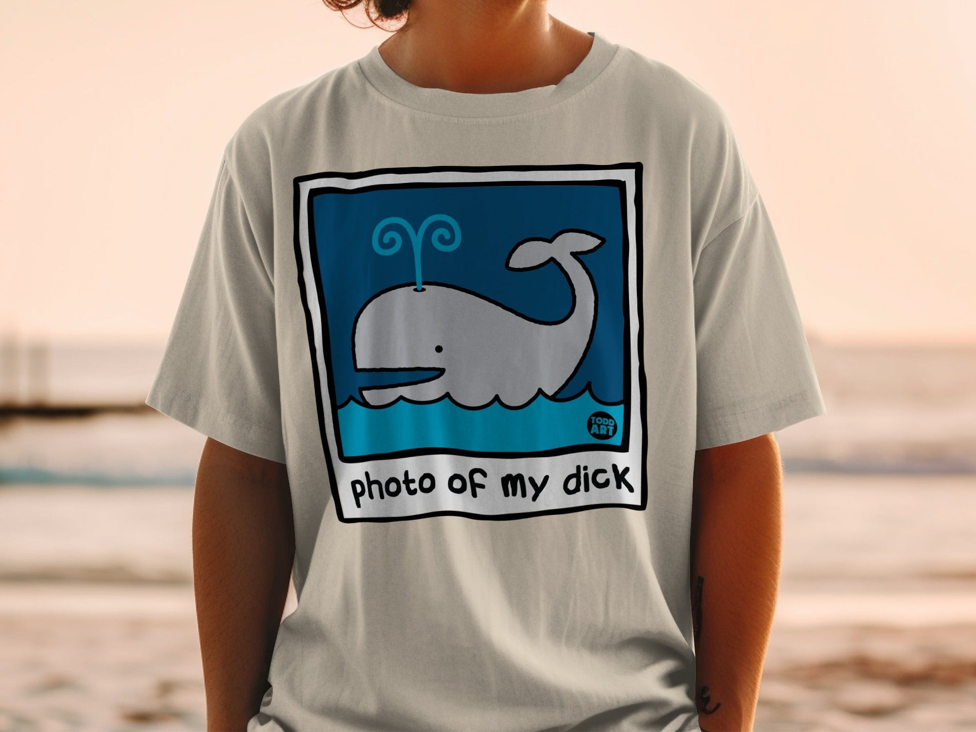 Light gray t-shirt with cartoon whale in blue square and text "photo of my dick".