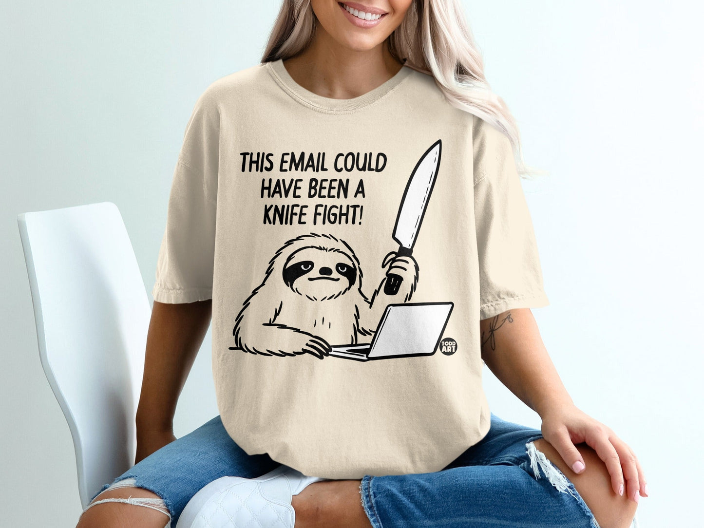 T-shirt with a drawing of a sloth holding a knife over a laptop, reading "THIS EMAIL COULD HAVE BEEN A KNIFE FIGHT!".