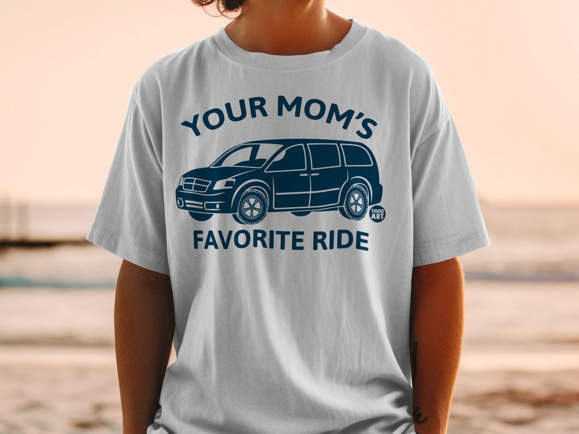 White t-shirt with "YOUR MOM'S FAVORITE RIDE" and a minivan graphic.