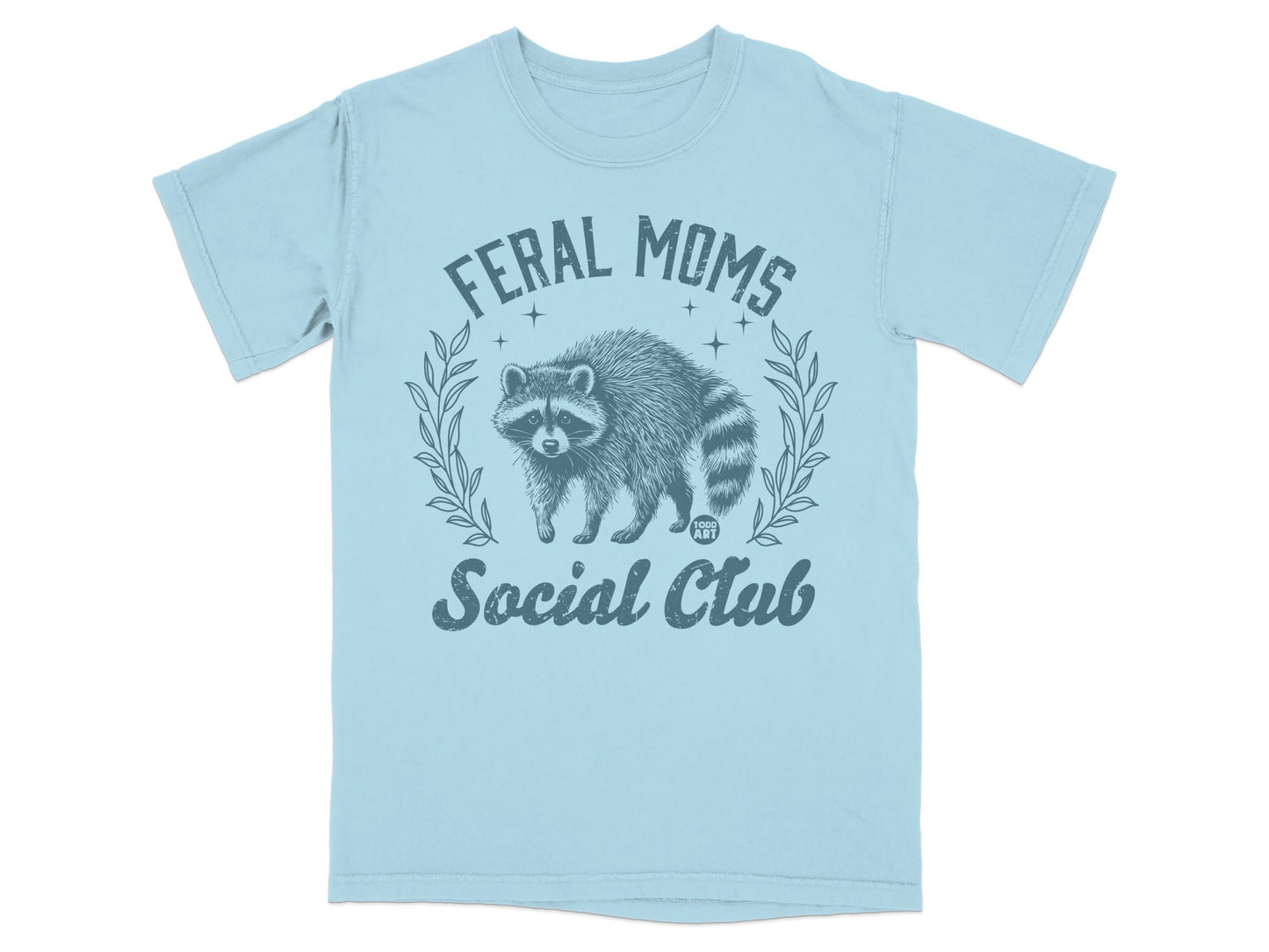 Light blue t-shirt with distressed raccoon graphic and text "Feral Moms Social Club".