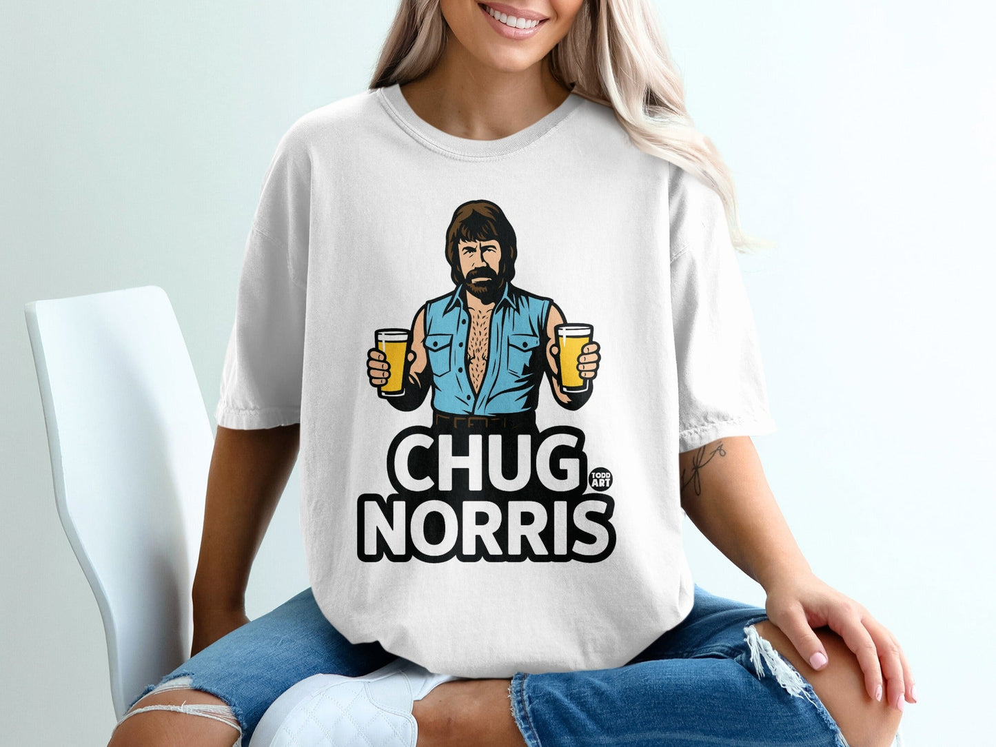 Chuck Norris graphic on a white t-shirt holding two beers.