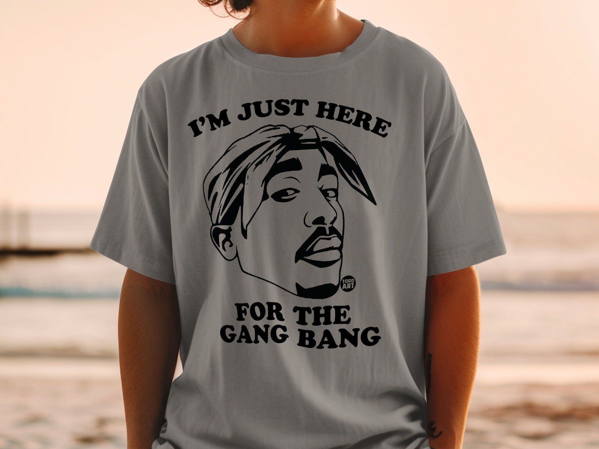 Gray t-shirt featuring Tupac Shakur portrait with text "I'M JUST HERE FOR THE GANG BANG".
