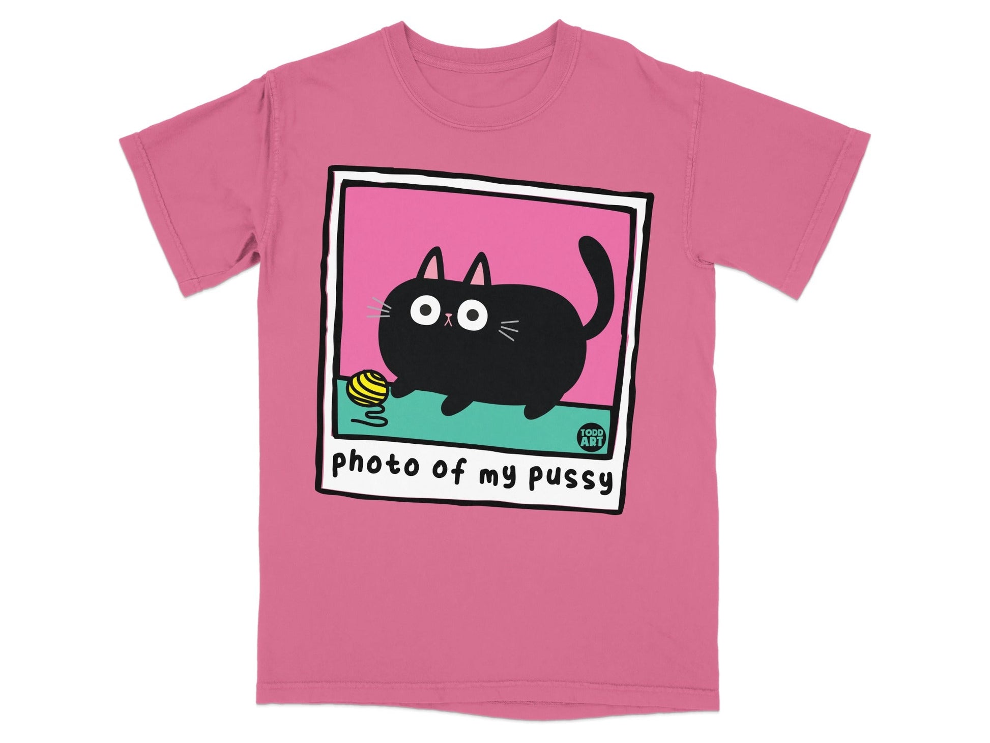 Pink t-shirt with a cartoon black cat playing with yarn in a polaroid frame.