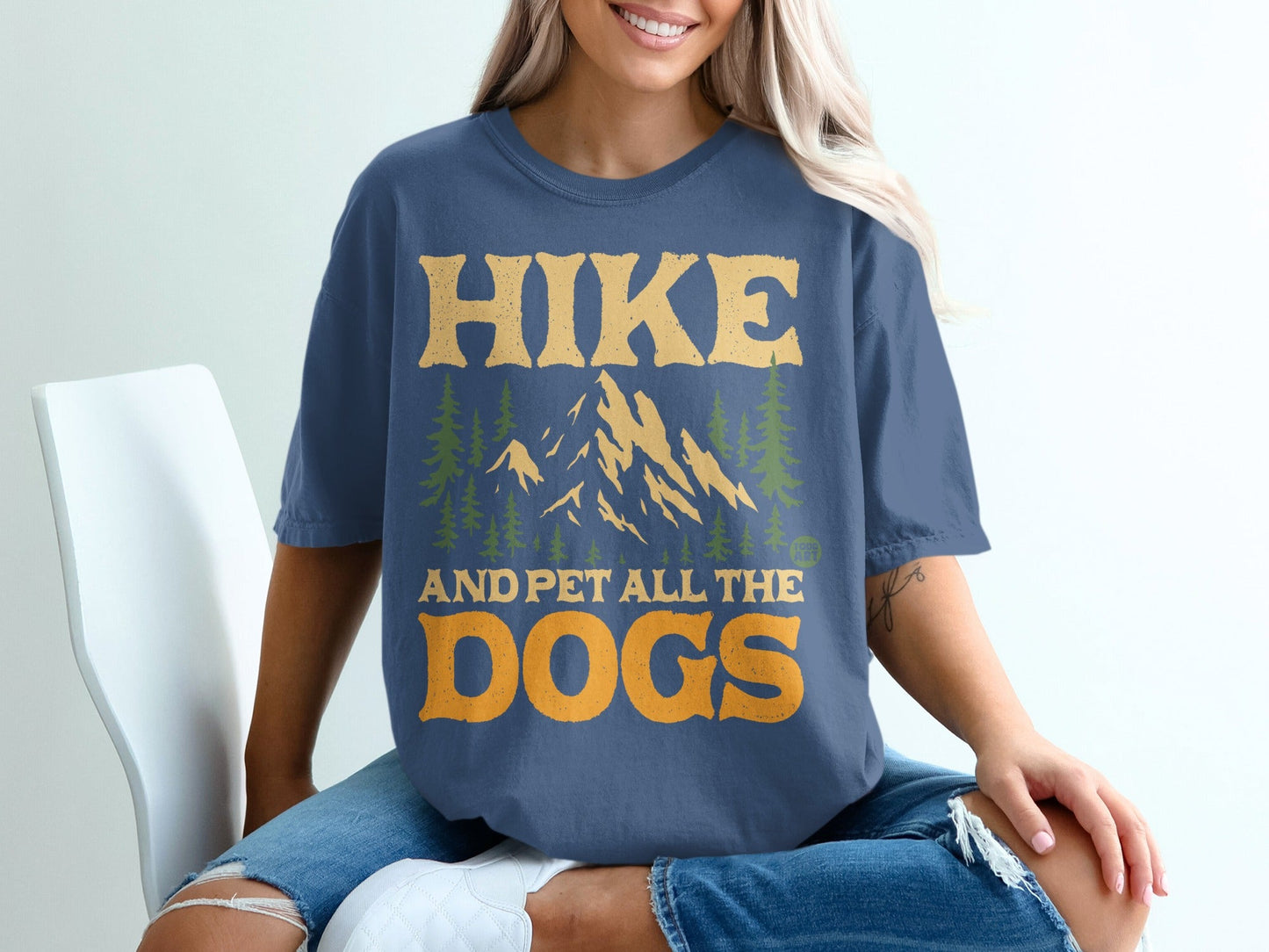 Dark blue t-shirt with "HIKE AND PET ALL THE DOGS" text and mountain graphic.