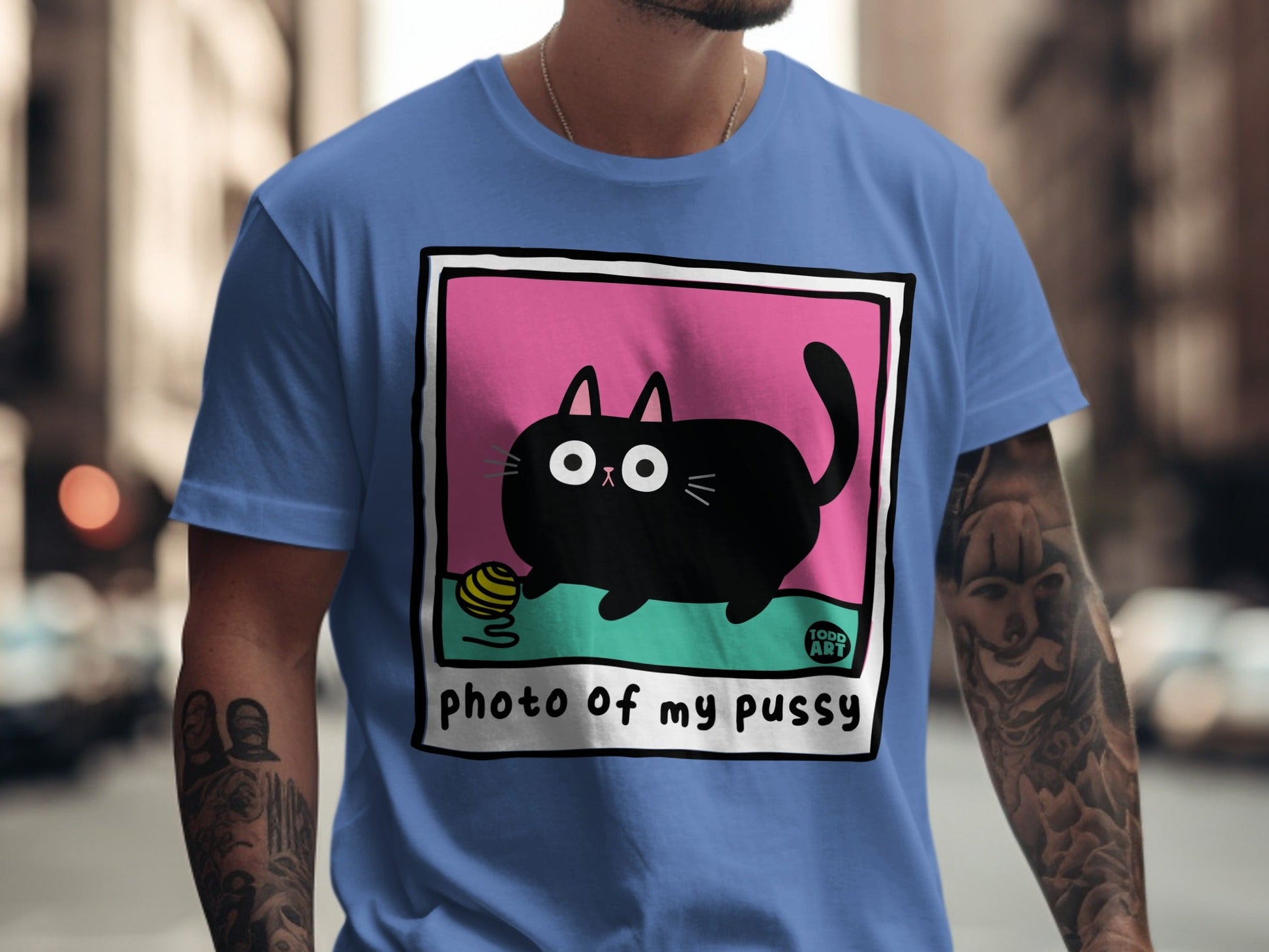 Black cat with yarn ball on pink and green background, text "PHOTO of my pussy".