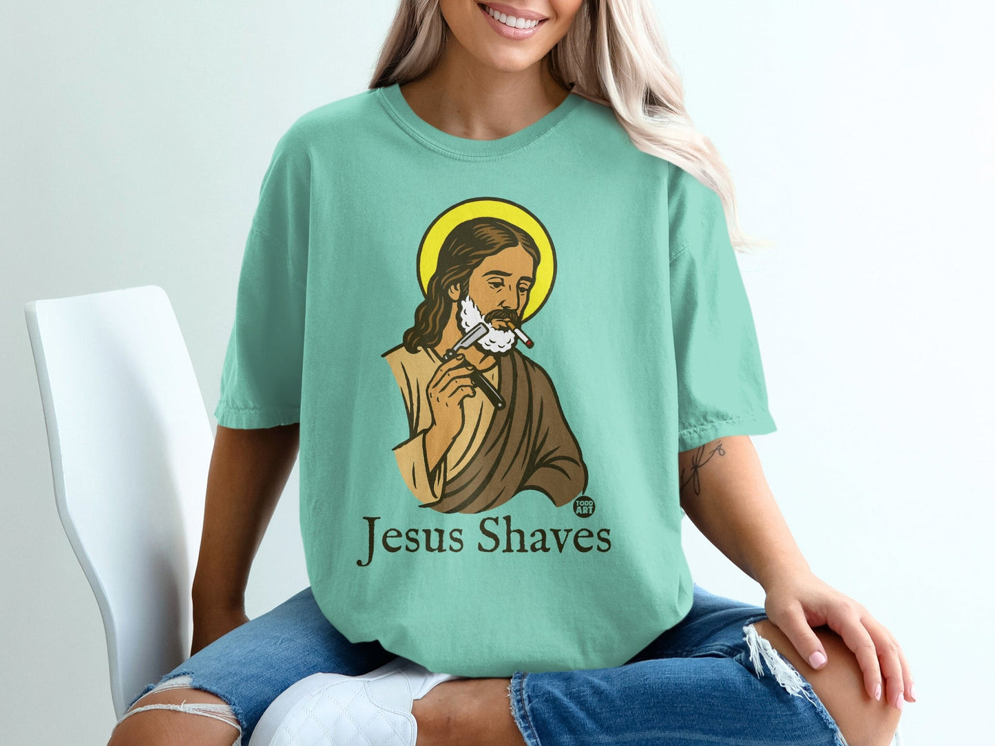 Jesus shaves with a razor in this mint green t-shirt graphic.