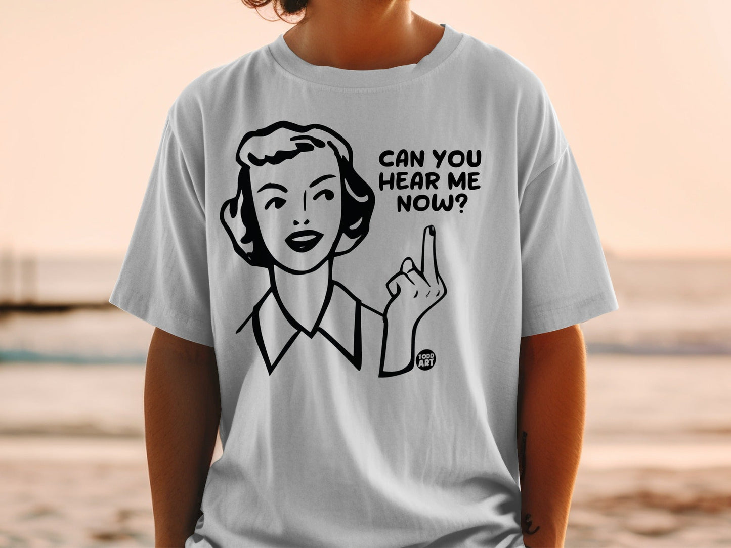 White t-shirt with black line art of a woman saying "CAN YOU HEAR ME NOW?"