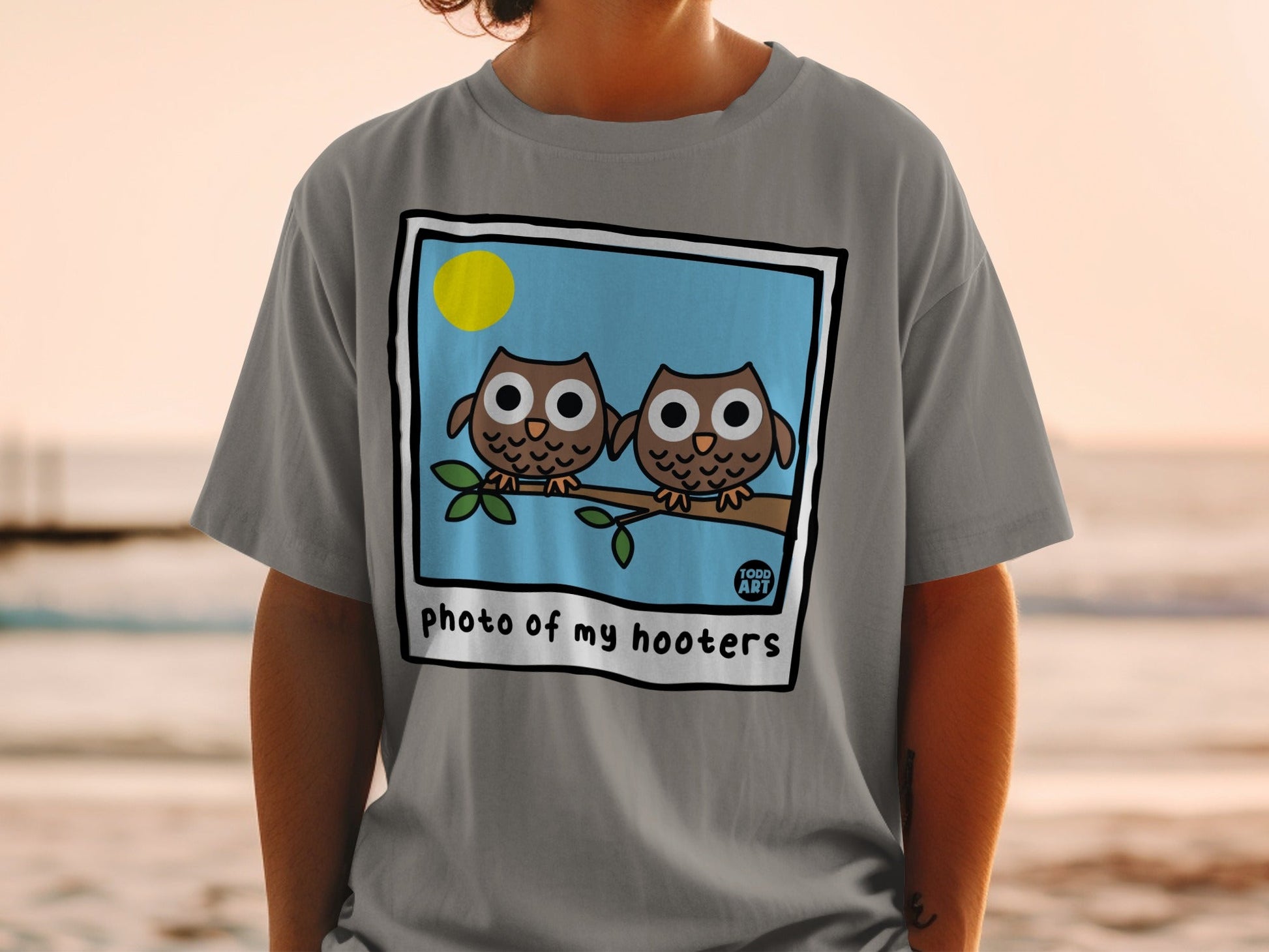 Cartoon owls on a branch with "photo of my hooters" text.