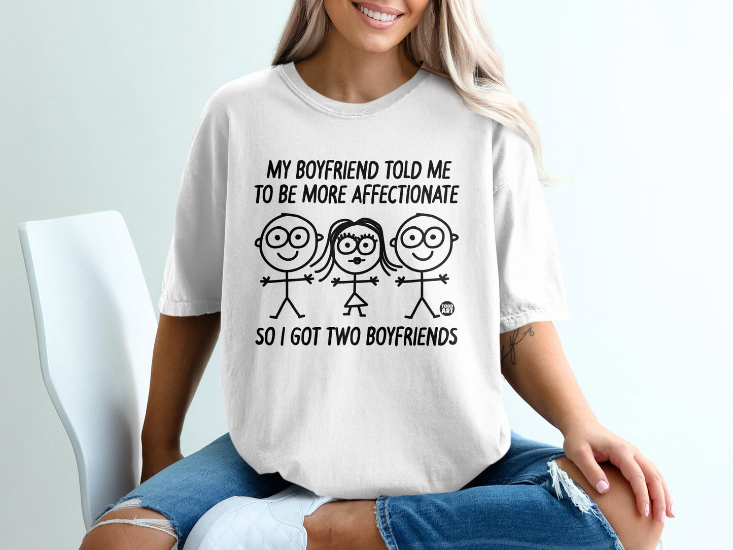 White t-shirt with text and cartoon figures about having two boyfriends.