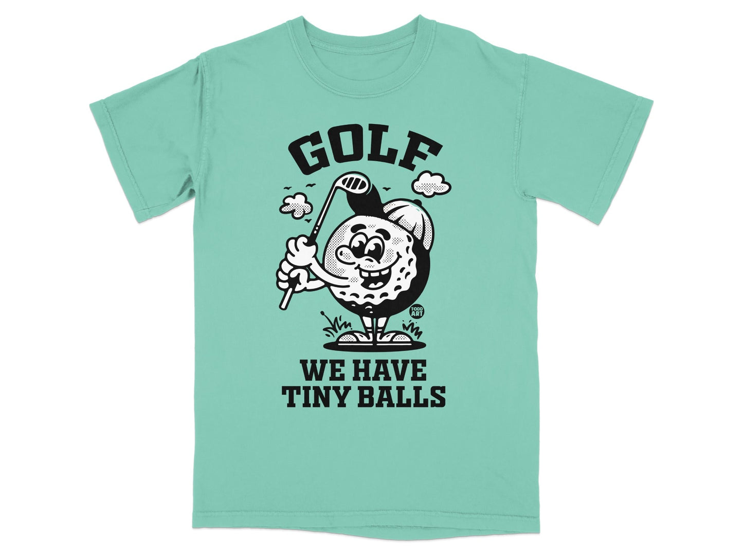 Cartoon golf ball character swinging club on t-shirt, text "GOLF WE HAVE TINY BALLS".