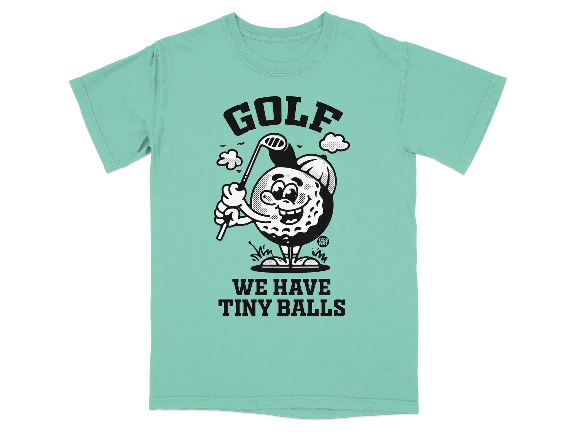 Cartoon golf ball character swinging club on t-shirt, text "GOLF WE HAVE TINY BALLS".
