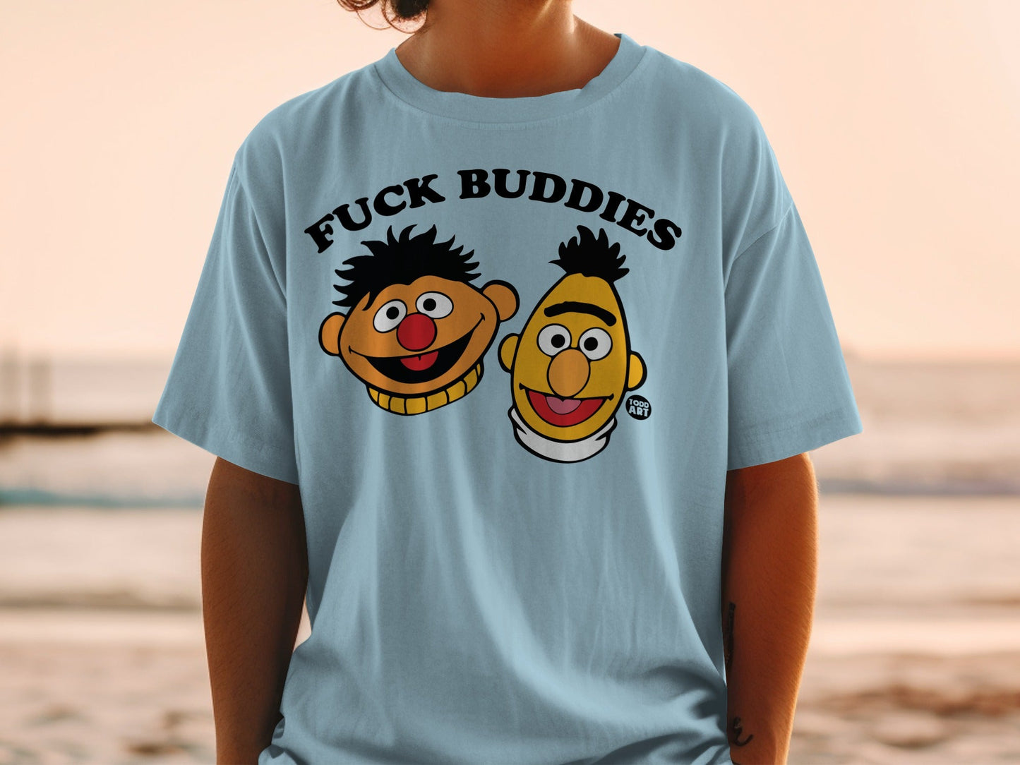 Light blue t-shirt with cartoon faces and "FUCK BUDDIES" text.