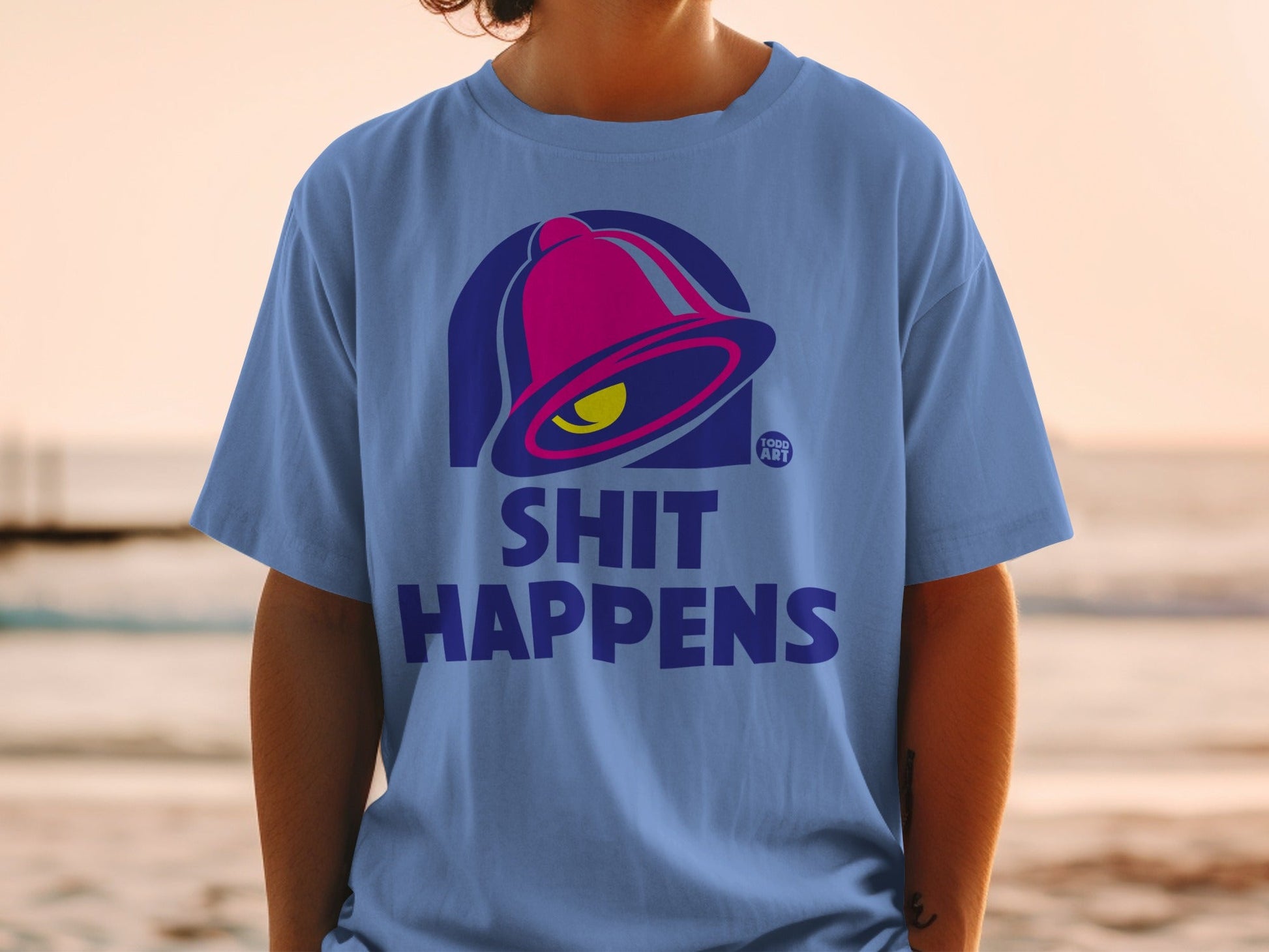 Blue t-shirt with Taco Bell logo and "Shit Happens" text.