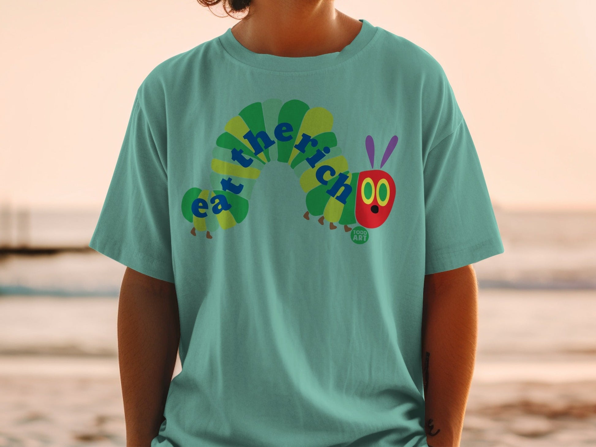 Green t-shirt with "The Very Hungry Caterpillar" graphic.