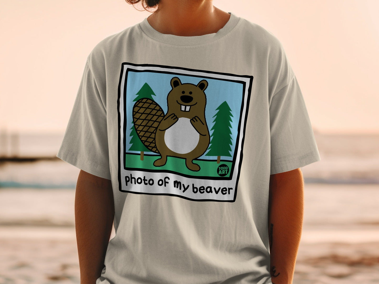 T-shirt with cartoon beaver and trees, text "photo of my beaver".