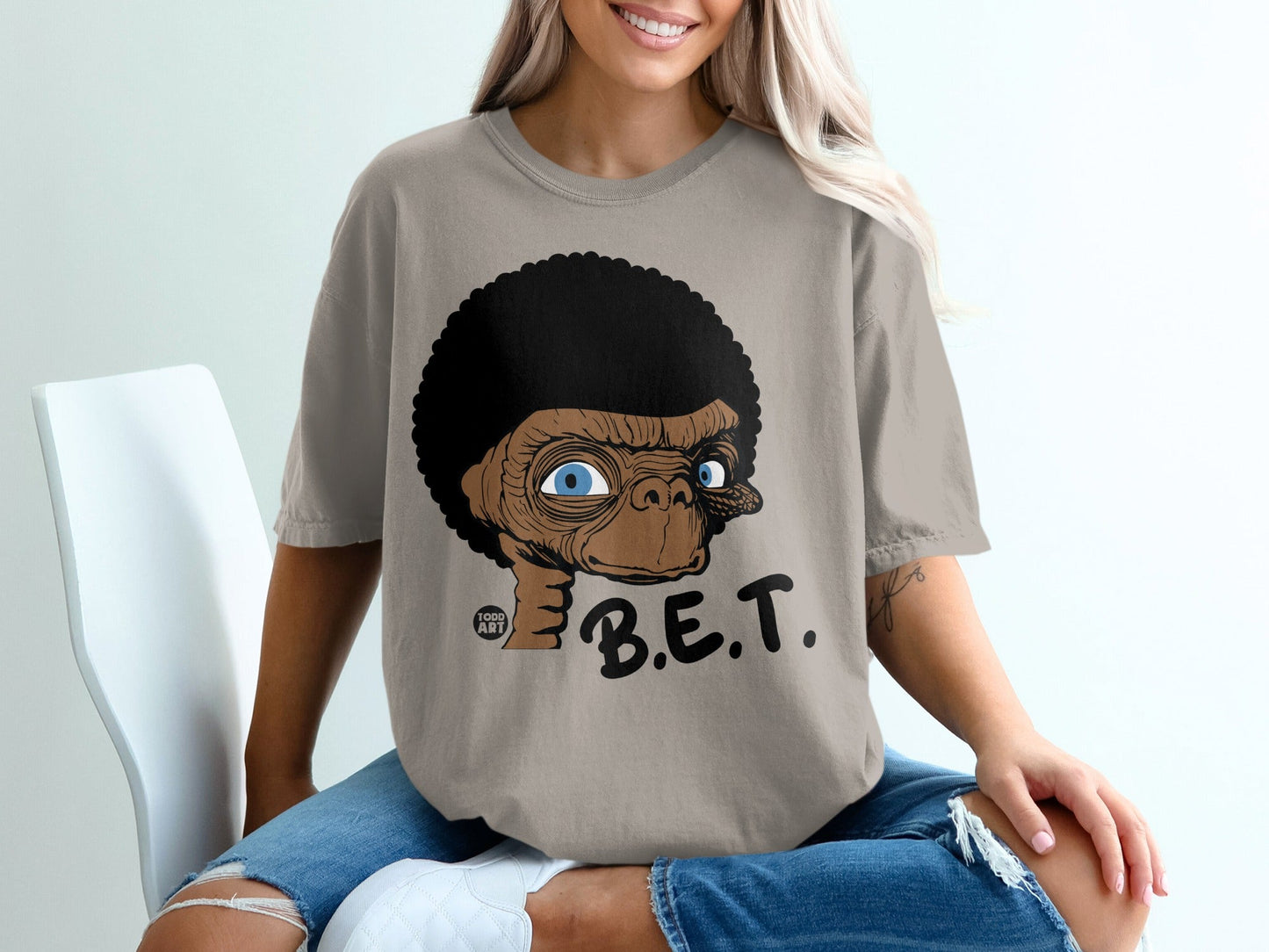 E.T. with an afro and the text "B.E.T." on a tan t-shirt.