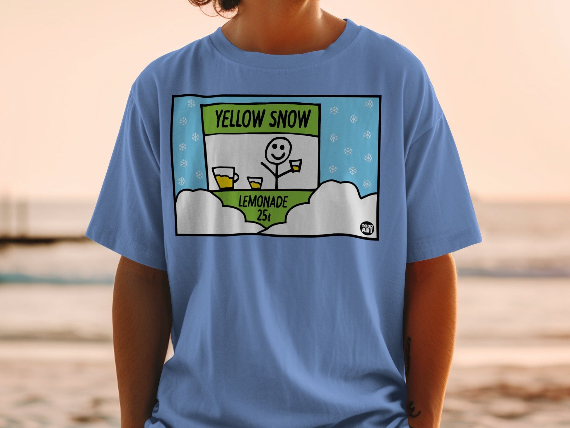 Blue t-shirt with a cartoon drawing of a lemonade stand selling "Yellow Snow Lemonade" for 25 cents.