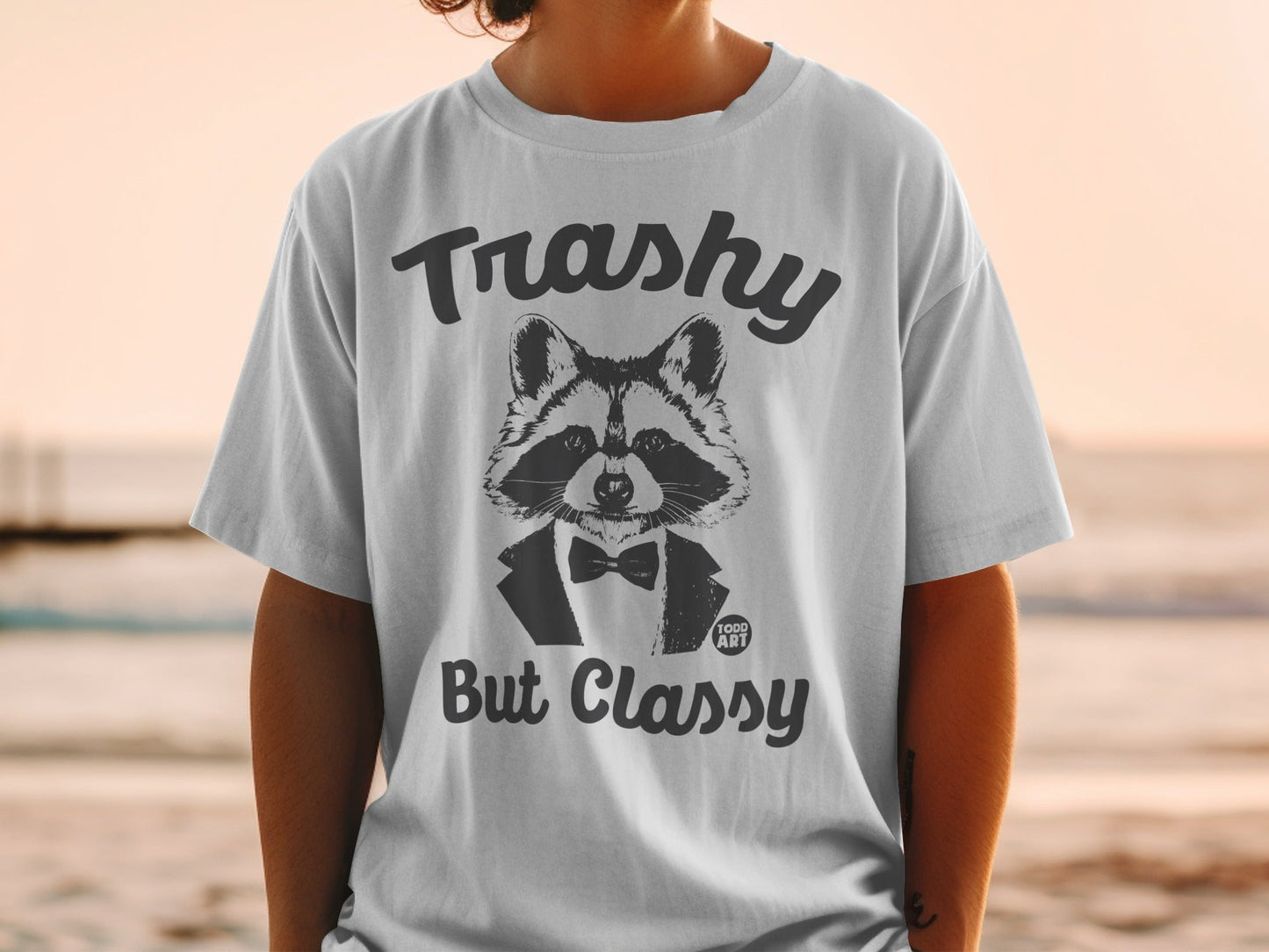 T-shirt with a raccoon wearing a tuxedo and bowtie, text reads "Trashy But Classy".