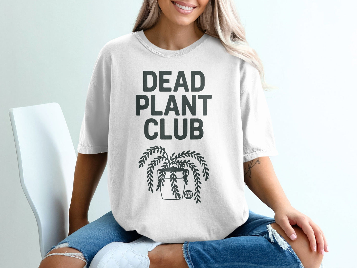 White t-shirt with "DEAD PLANT CLUB" and a potted plant graphic.