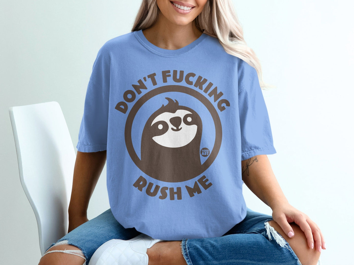 Blue t-shirt with brown sloth graphic and text "DON'T FUCKING RUSH ME".
